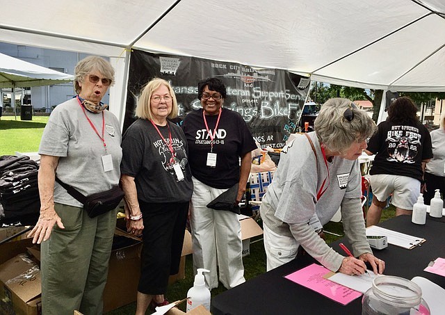 Jeri Beliveau registers a biker with, from left, Bert Manning, Joy Ann Miles and Sheila Middleton. - Submitted photo