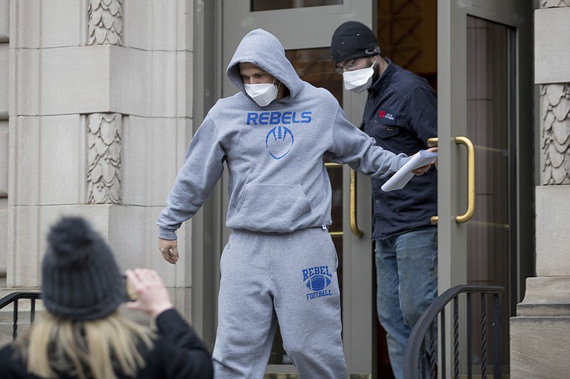 FILE - Derrick Evans exits the Sidney L. Christie U.S. Courthouse and Federal Building after being arraigned, Jan. 8, 2021, in Huntington, W.Va. The former West Virginia lawmaker who livestreamed himself on Facebook storming the U.S. Capitol and cheering on what he described as a “revolution” has been sentenced to three months in prison. (Sholten Singer/The Herald-Dispatch via AP)