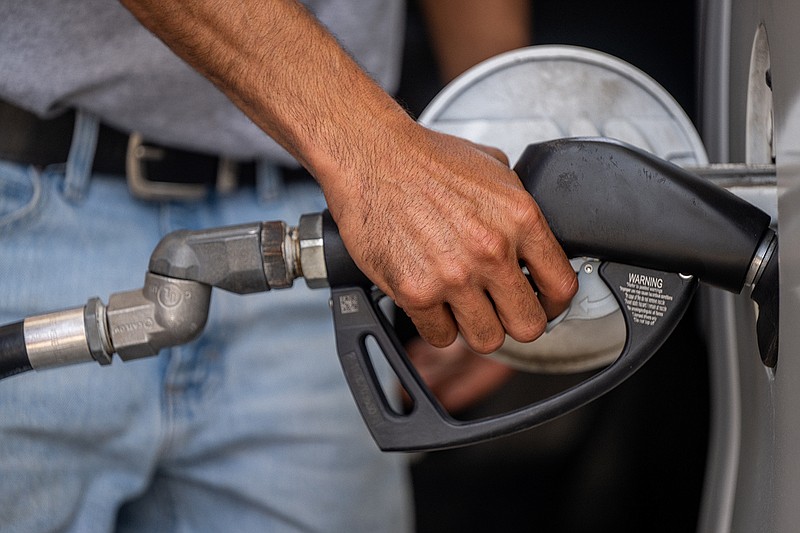 TNS
Guy Benhamou pumps gas at an Exxon Mobil gas station in Houston, Texas. Gas prices are breaching record highs as demand increases and supply fails to keep up.