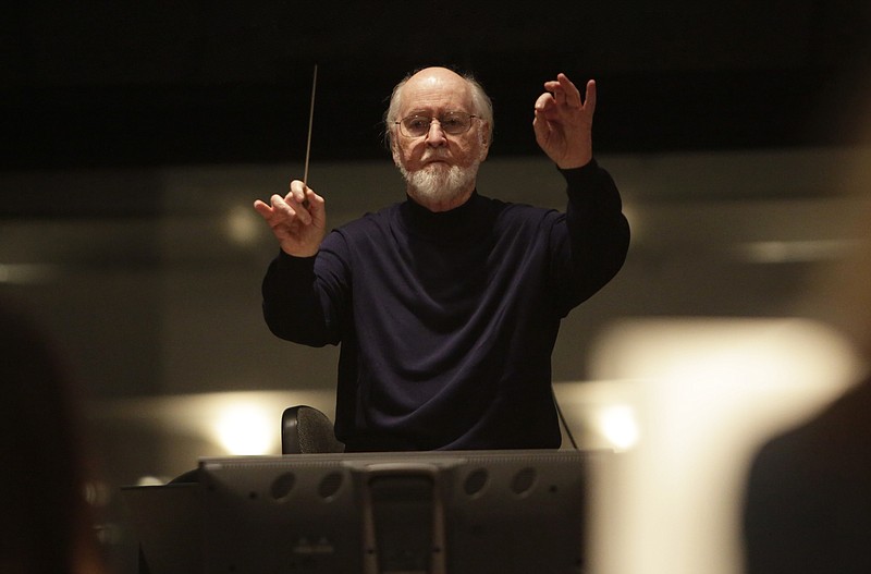 This 2017 photo released by Lucasfilm Ltd. shows John Williams, a five-time Oscar-winning composer. Williams, 90, is devoting himself to composing concert music, including a piano concerto he&#x2019;s writing for Emanuel X. This spring, he and cellist Yo-Yo Ma released the album &#x201c;A Gathering of Friends,&#x201d; recorded with the New York Philharmonic. (Jamie Trueblood/Lucasfilm Ltd. via AP)