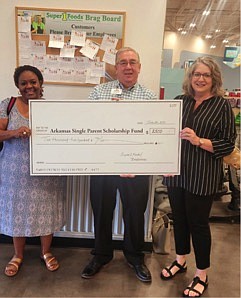 Les Ferguson, Super 1 Foods Texarkana Store Manager, presents a donation check to Arkansas Single Parent Scholarship Fund Program Manager Sandra Warren (right) and ASPSF Fund Development Manager Wendy Stotts. (Photo Courtesy Sandra Warren/ASPSF)