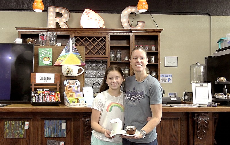 RC Coffee and Collectables owner Renee Altamirano, right, and her daughter, Isabella, display a drink and a baked good.  - Photo by Andrew Mobley of The Sentinel-Record.