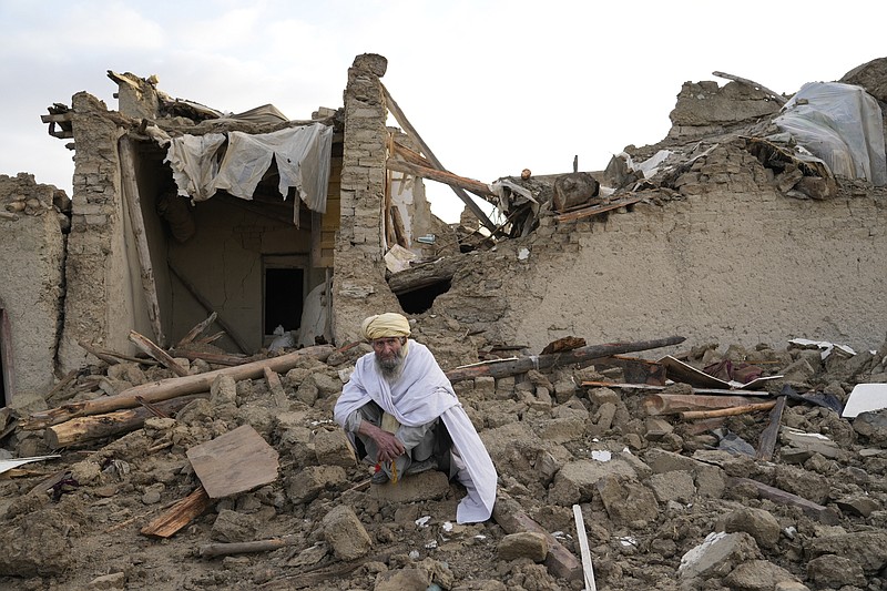 An Afghan sits by the rubble of his house earthquake in Gayan village, in Paktika province, Afghanistan, Thursday, June 23, 2022. A powerful earthquake struck a rugged, mountainous region of eastern Afghanistan early Wednesday, flattening stone and mud-brick homes in the country's deadliest quake in two decades, the state-run news agency reported. (AP Photo/Ebrahim Nooroozi)