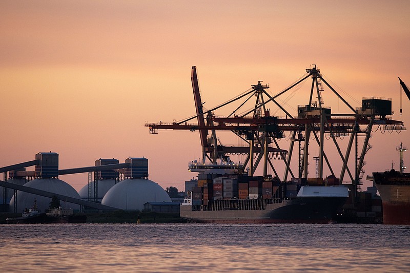 A container ship and fertilizer terminal, left, on the Daugava River at Riga Free Port in Riga, Latvia, on Thursday, June 16, 2022. MUST CREDIT: Bloomberg photo by Andrey Rudakov
