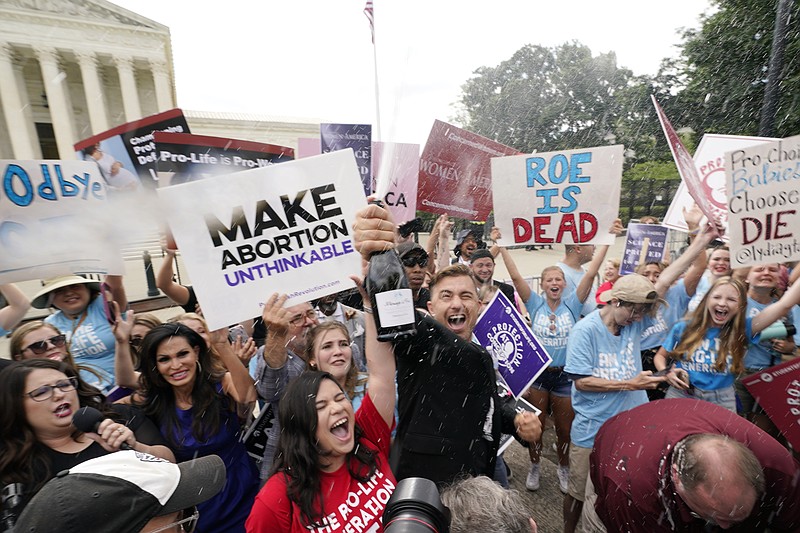 Abortion opposers celebrate outside the Supreme Court on Friday, June 24, 2022, in Washington. The Supreme Court has ended constitutional protections for abortion that had been in place nearly 50 years — a decision by its conservative majority to overturn the court's landmark abortion cases. (AP Photo/Steve Helber)