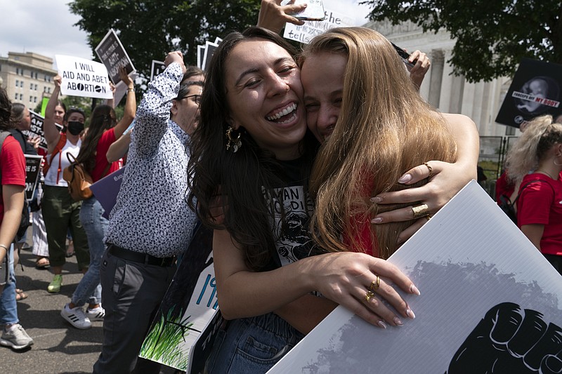 Anti-abortion protesters celebrate after the news of Supreme Court overturned Roe v. Wade outside the Supreme Court on Friday, June 24, 2022, in Washington. The Supreme Court has ended constitutional protections for abortion that had been in place nearly 50 years, a decision by its conservative majority to overturn the court's landmark abortion cases. (AP Photo/Jose Luis Magana)