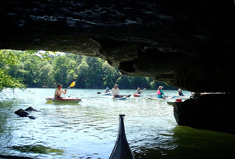 Paddlers are seen from inside Page Sawmill Cave on Beaver Lake at Hobbs State Park-Conservation Area. Numerous caves in the 12,000-acre park are an example of karst topography, which is prevalent in the Ozarks.
(NWA Democrat-Gazette/Flip Putthoff)
