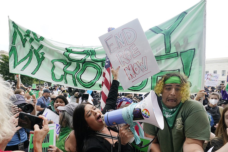 People protest about abortion, Friday, June 24, 2022, outside the Supreme Court in Washington. (AP Photo/Steve Helber)