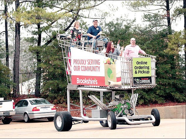 Cart return: Brookshire’s employees ride the 13 foot-tall motorized grocery cart in the parking lot of the North West Avenue store. The group celebrated renovations at the store in 2020. People who attend Summer on the Square Saturday will have an opportunity to take a photo with the giant Brookshire's shopping cart. (Contributed)