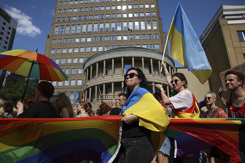 People take part in the 'Warsaw and Kyiv Pride' march for freedom in Warsaw, Poland, Saturday, June 25, 2022. Due to Russia's full-scale war against Ukraine the 10th anniversary of the equality march in Kyiv can't take place in the usual format in the Ukrainian capital. The event joined Warsaw's yearly equality parade, the largest gay pride event in central Europe, using it as a platform to keep international attention focused on the Ukrainian struggle for freedom. (AP Photo/Michal Dyjuk)