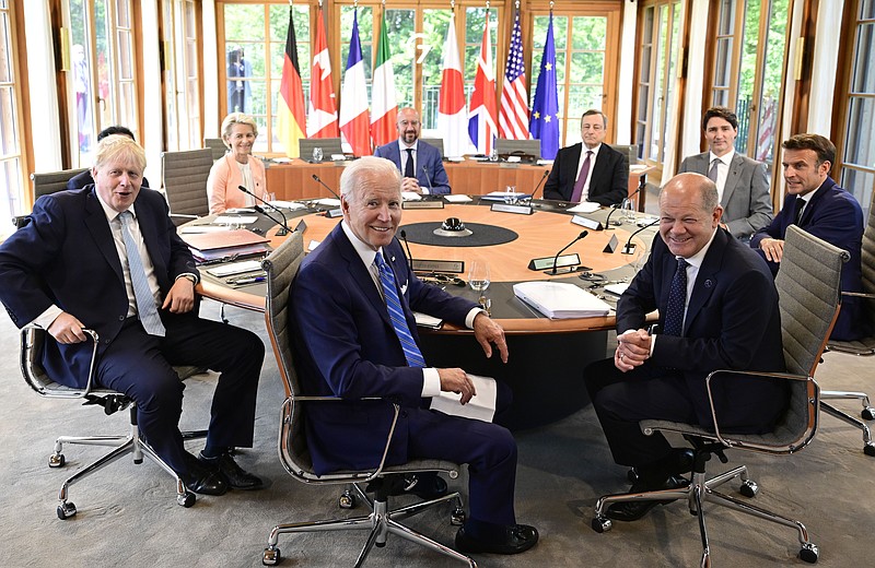 Clockwise from left, Fumio Kishida (covered), Prime Minister of Japan, Ursula von der Leyen, President of the European Commission, Charles Michel, President of the European Council, Mario Draghi, Prime Minister of Italy, Justin Trudeau, Prime Minister of Canada, Emmanuel Macron, Prime Minister of France, German Chancellor Olaf Scholz, US President Joe Biden and Boris Johnson, Prime Minister of the United Kingdom sit at the first working session in Castle Elmau in Kruen, near Garmisch-Partenkirchen, Germany, on Sunday, June 26, 2022. The Group of Seven leading economic powers are meeting in Germany for their annual gathering Sunday through Tuesday. (John MacDougall/Pool Photo via AP)