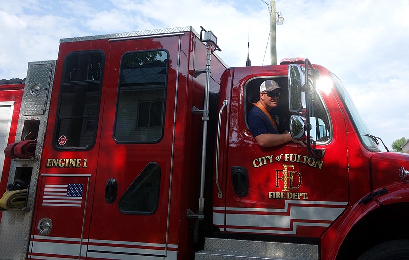 Fulton firefighters wave from a truck during the Fulton Street Fair parade on Saturday evening, June 25, 2022. (FULTON SUN PHOTO/MICHAEL SHINE)