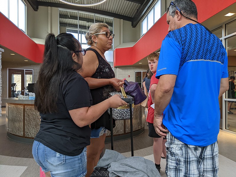 Victoria Pineda waits in line with her parents Aravella and Juan to register medication Sunday, June 26, 2022, at Special Olympics Missouri Gary Brimer Sports Camp. Special Olympics Missouri has hosted the sports camp for 26 years but only located it at the Training for Life Campus in Jefferson City. (Ryan Pivoney/News Tribune photo)