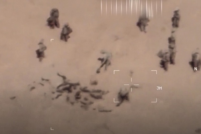 FILE - This undated image taken from a video shows soldiers burying bodies near an army base in northern Mali. The French military says it has videos of Russian mercenaries burying bodies near an army base in northern Mali. Russia has engaged in under-the-radar military operations in at least half a dozen countries in Africa in the last five years using a shadowy mercenary force analysts say is loyal to President Vladimir Putin. Russia’s invasion of Ukraine is certain to dominate an upcoming NATO summit in Madrid. But host nation Spain and other members are quietly pushing the Western alliance to consider how mercenaries aligned with Russian President Vladimir Putin are spreading Moscow’s influence in Africa.. (French Army via AP, File)