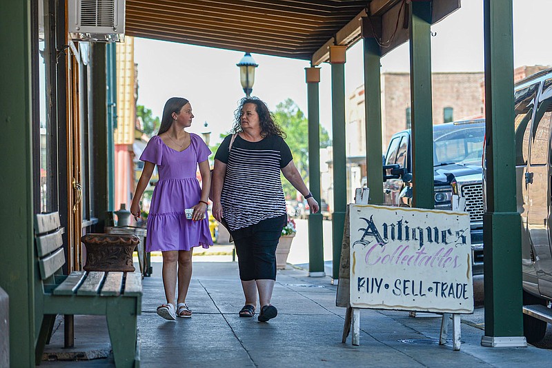 Lori Suggs (right) and Kaylynn Suggs, both of Van Buren, walk past storefronts on Thursday, June 30, 2022, in the Van Buren Historic District in downtown Van Buren. The Van Buren City Council voted Monday to approve an ordinance establishing two entertainment districts in the city, according to the City Clerkâ€™s Office. The two new entertainment districts, which collectively form the Main Street Entertainment District, comprise the 600 block and part of the 800 block of Main Street in downtown Van Buren, the ordinance states. Visit nwaonline.com/220703Daily/ for today's photo gallery.
(NWA Democrat-Gazette/Hank Layton)