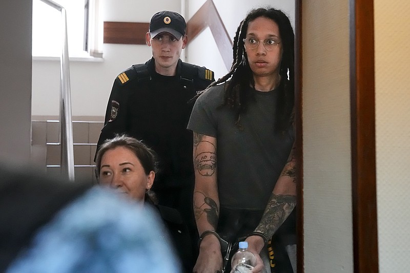 WNBA star and two-time Olympic gold medalist Brittney Griner is escorted to a courtroom for a hearing in Khimki just outside Moscow, Russia, Monday. More than four months after she was arrested at a Moscow airport for cannabis possession, the American basketball star appeared in court Monday for a preliminary hearing ahead of her trial. - Photo by Alexander Zemlianichenko of The Associated Press
