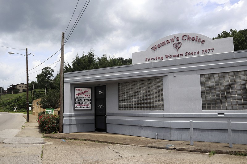 A sign advertises free pregnancy tests and abortion information outside the Woman's Choice Pregnancy Resource Center in Charleston, W.Va., on Friday June 17, 2022. The anti-abortion center is located next to Women's Health Center of West Virginia, seen in background left, the only abortion provider in the state. (AP Photo/Leah M. Willingham)