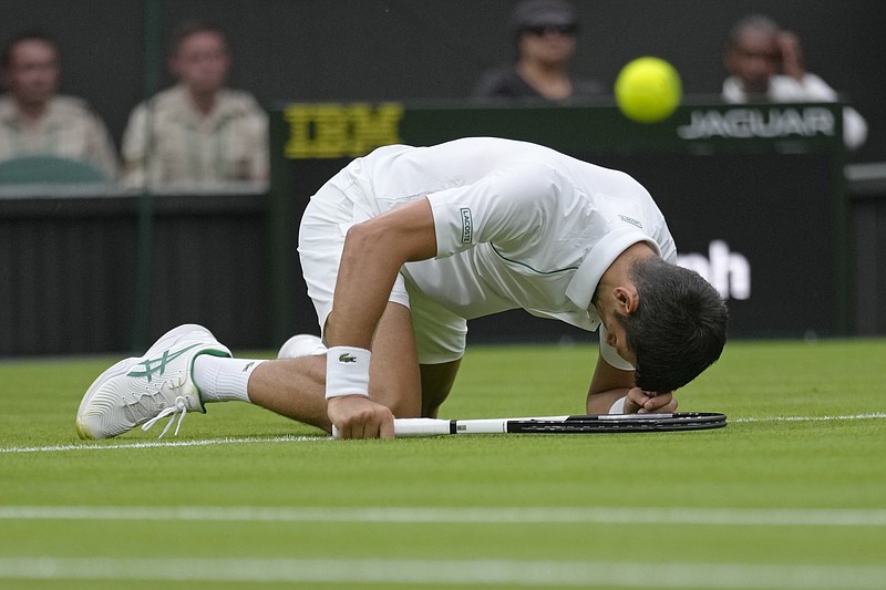Serbia's Novak Djokovic slips over as he plays Korea's Kwon Soonwoo in a men's first round singles match on day one of the Wimbledon tennis championships in London Monday. - Photo by Kirsty Wigglesworth of The Associated Press