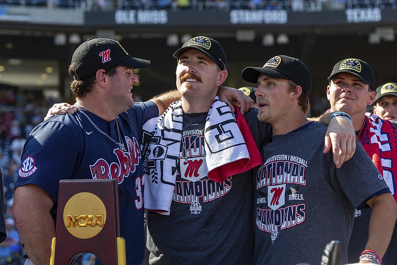 Mississippi's Ben Van Cleve (33), Tim Elko (25) and Justin Bench (8) look on during the closing video after a win over Oklahoma in Game 2 of the NCAA College World Series baseball finals, Sunday, June 26, 2022, in Omaha, Neb. (AP Photo/John Peterson)