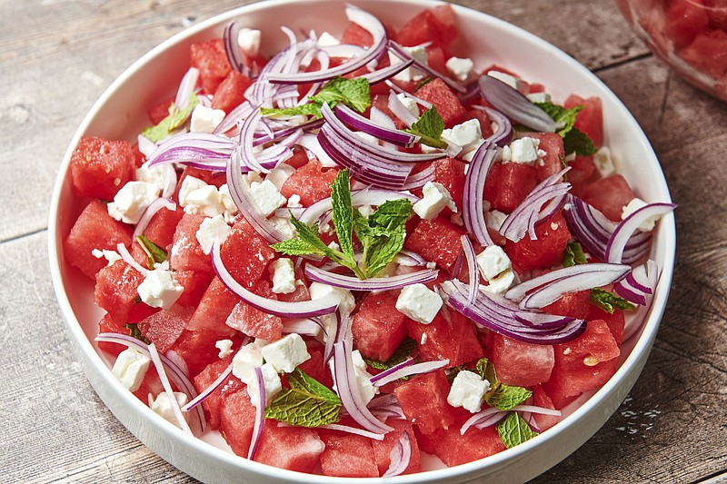 AP
This image shows a recipe for watermelon feta salad topped with thinly sliced red onion and mint leaves.