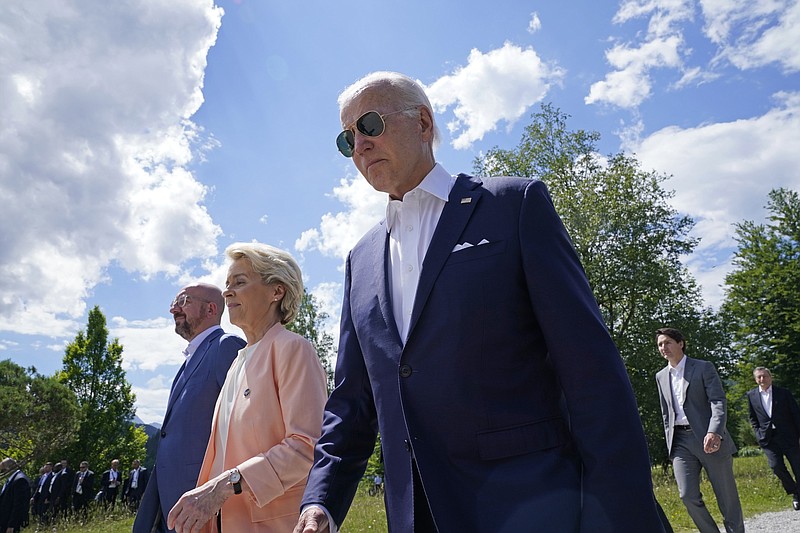 President Joe Biden, right, walks with European Commission President Ursula von der Leyen, center, and European Council President Charles Michel, left, as they head to a family photo with the G7 leaders at the G7 Summit in Elmau, Germany, Sunday, June 26, 2022. (AP Photo/Susan Walsh, Pool)