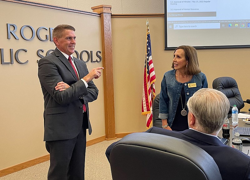 NWA Democrat-Gazette/DAVE PEROZEK Jeff Perry, left, talks with Rogers School Board members Paige Sultemeier and Mitch Lockhart before the board's meeting on Tuesday, June 21, 2022. Perry is preparing to take over as the Rogers School District's superintendent on July 1.