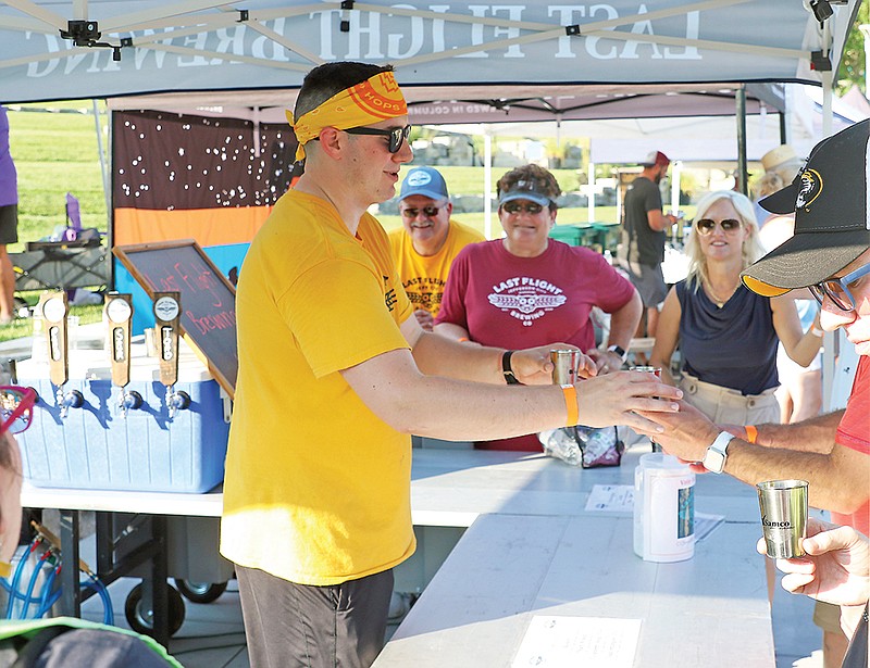 Several local brewers, like Will Cooper of Last Flight Brewing, served a steady steam of people during s previous Battle of the Brews at Central Region MU Health Care Amphitheater. In addition to samples of beer, the annual event features live music, yard games, food trucks and vendors plus a photo booth. (Jason Strickland/News Tribune file photo)
