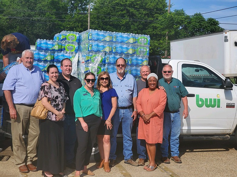 Members of the Greater Texarkana Young Professionals, Texarkana Sunrise Rotary Club, BWI Companies and Randy Sams' Outreach Shelter gather as the shelter receives a large donation of bottled water for its clients and local homeless population on Tuesday, June 28, 2022, in Texarkana, Texas. (Submitted photo)