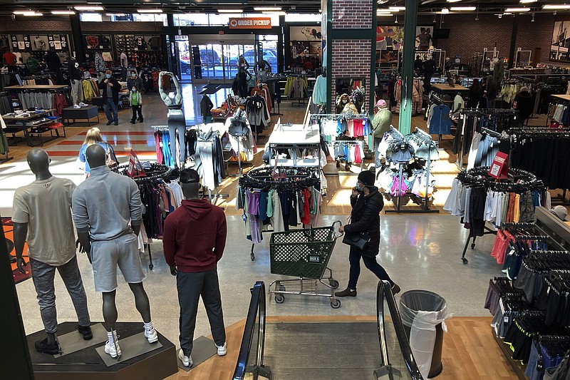 FILE - Shoppers shop at a retail store in Niles, Ill., on Feb. 19, 2022.   U.S. consumer confidence edged down in May as Americans’ view of their present and future prospects dimmed in the midst of persistent inflation. The Conference Board said Tuesday, May 31, 2022,  that its consumer confidence index dipped to 106.4 in May from 108.6 in April. (AP Photo/Nam Y. Huh, File)