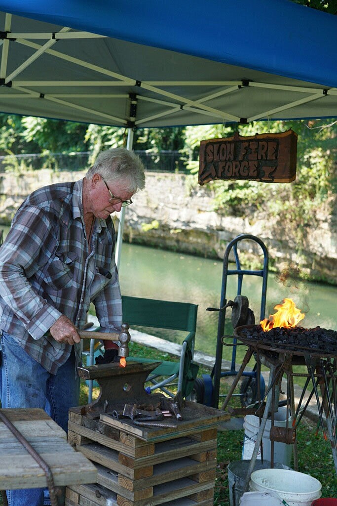 Courtesy of Naomi Terhune Blacksmith Steve Low works with a hammer and anvil at the Heritage Festival.