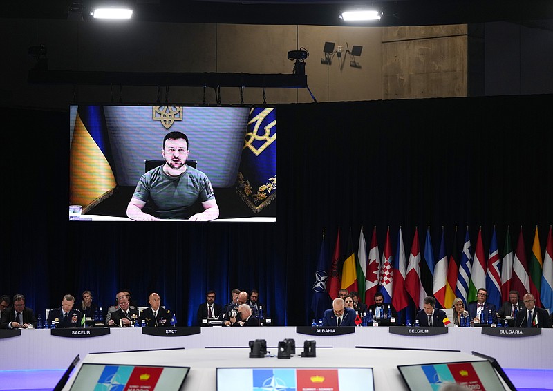 Ukraine's President Volodymyr Zelenskyy addresses leaders via a video screen during a roundtable meeting at a NATO summit Wednesday, June 29, 2022, in Madrid. North Atlantic Treaty Organization heads of state meet for a NATO summit in Madrid from Tuesday through Thursday. (AP Photo/Manu Fernandez)