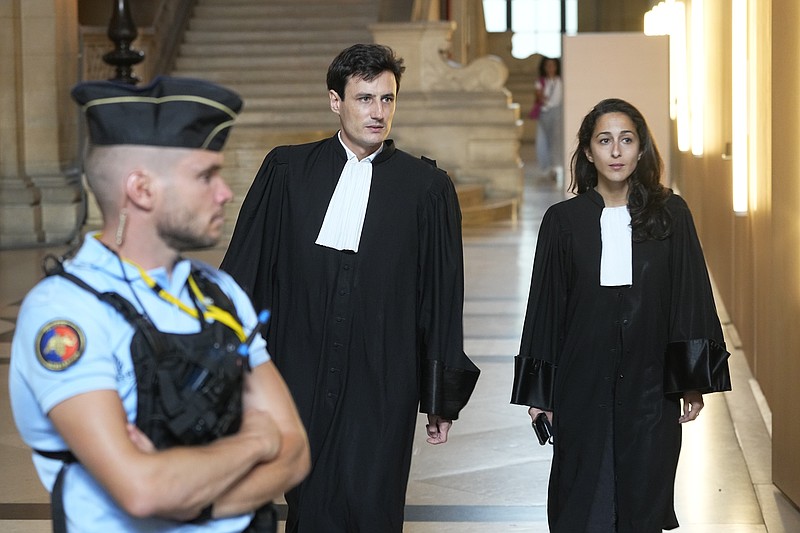 Salah Abdeslam's lawyers Olivia Ronen, right, and Martin Vettes arrive at the court room Wednesday, June 29, 2022 in Paris. Over the course of an extraordinary nine-month trial, the lone survivor of the Islamic State extremist team that attacked Paris in 2015 has proclaimed his radicalism, wept, apologized to victims and pleaded with judges to forgive his &quot;mistakes.&quot; For victims' families and survivors of the attacks, the trial for Salah Abdeslam and suspected accomplices has been excruciating yet crucial in their quest for justice and closure. At long last, the court will hand down its verdict Wednesday. (AP Photo/Michel Euler)