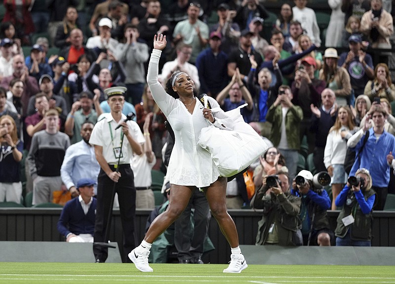 Serena Williams of the US waves as she leaves the court after losing to France's Harmony Tan in a first round women’s singles match on day two of Wimbledon Tuesday in London. - Photo by John Walton of PA via The Associated Press