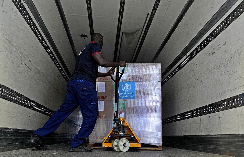 A man loads healthcare material to be sent to Afghanistan, at a UNHCR warehouse, part of the International Humanitarian City in Dubai, United Arab Emirates, Monday, June 27, 2022. (AP Photo/Kamran Jebreili)