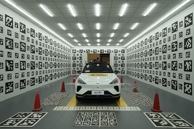 A self-driving taxi developed by tech giant Baidu Inc. is seen in a chamber used to calibrate its sensors, on June 14, 2022, in Beijing. Baidu Inc. is China's highest-profile competitor in a multibillion-dollar race with Alphabet Inc.'s Waymo and General Motors Co.'s Cruise to create self-driving cars. (AP Photo/Ng Han Guan)