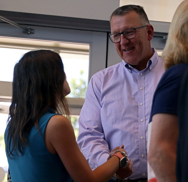 People gather at a farewell party for Larry Linthacum on Tuesday, June 28, 2022, at Miller Performing Arts Center. 
Kate Cassady/News Tribune
Larry Linthacum, right, shakes hands with Mayor Carrie Tergin.