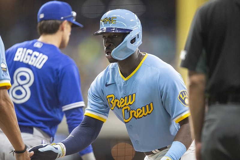 Photo taken and provided by the Milwaukee Brewers.
Jonathan Davis high-fives a team.