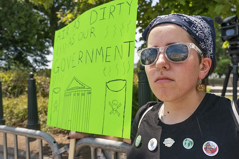 Erin Tinerella, of Chicago, who is in Washington for the summer at an internship, protests against climate change after the Supreme Court's EPA decision, Thursday, June 30, 2022, at the Supreme Court in Washington. (AP Photo/Jacquelyn Martin)