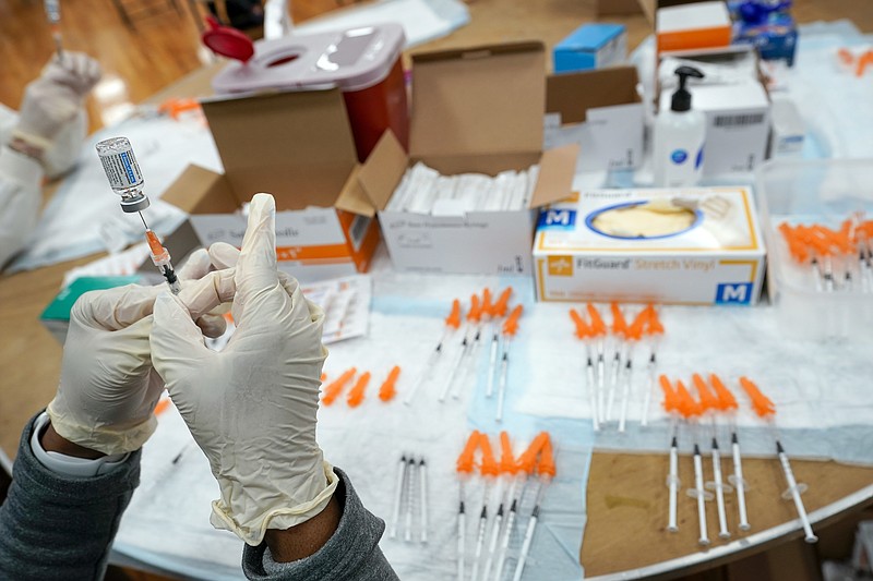 FILE - A Northwell Health registered nurse fills a syringe with a COVID-19 vaccine at a pop up vaccination site the Albanian Islamic Cultural Center, April 8, 2021, in the Staten Island borough of New York. The Food and Drug Administration on Thursday, June 30, 2022 recommended that COVID-19 booster shots be modified to better match more recent variants of the coronavirus. (AP Photo/Mary Altaffer, file)