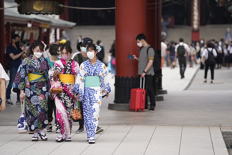 People visit Sensoji Buddhism temple in Tokyo's Asakusa area famous for sightseeing, Wednesday, June 22, 2022. Japan is bracing for a return of tourists from abroad, as border controls to curb the spread of coronavirus infections are gradually loosened. (AP Photo/Hiro Komae)
