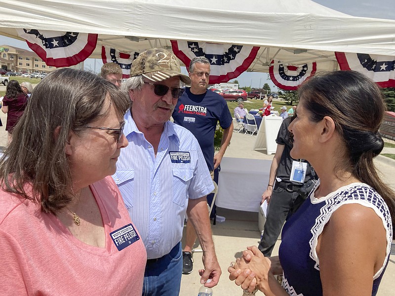 Former United Nations Ambassador Nikki Haley talks with Bob and Kathy de Koning, a farming couple from Sioux County, Iowa, Thursday, June 30, 2022, after headlining a fundraiser in northwest Iowa for Republican Rep. Randy Feenstra. (AP Photo/Tom Beaumont)