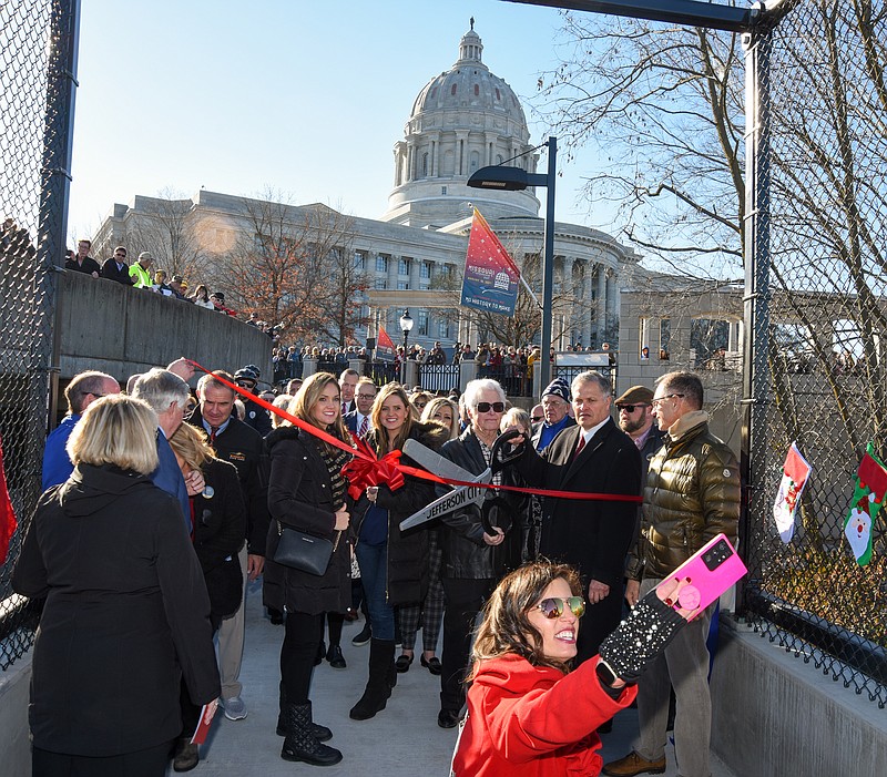 Never one to miss an opportunity for a selfie with the mayor, Carrie Tergin brought out her cell phone to get the dignitaries and donor families in a photograph before the ribbon was cut to officially allow public entry onto the Bicentennial Bridge. (Julie Smith/News Tribune file photo)