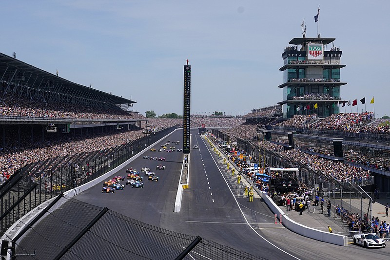 Scott Dixon, (9) of New Zealand, leads the field on the start of the the Indianapolis 500 auto race at Indianapolis Motor Speedway in Indianapolis, Sunday, May 29, 2022. The Speedway returned to full capacity for the first time since 2020, when the pandemic put an unforeseeable end to large group gatherings. More than 325,000 people attended the 2022 race. (AP Photo/Michael Conroy, File)