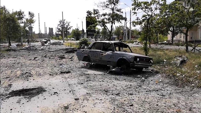 In this photo provided by the Luhansk region military administration, burned car and damaged residential buildings are seen in Lysychansk, Luhansk region, Ukraine, early Sunday, July 3, 2022. Russian forces pounded the city of Lysychansk and its surroundings in an all-out attempt to seize the last stronghold of resistance in eastern Ukraine's Luhansk province, the governor said Saturday. A presidential adviser said its fate would be decided within the next two days. (Luhansk region military administration via AP)