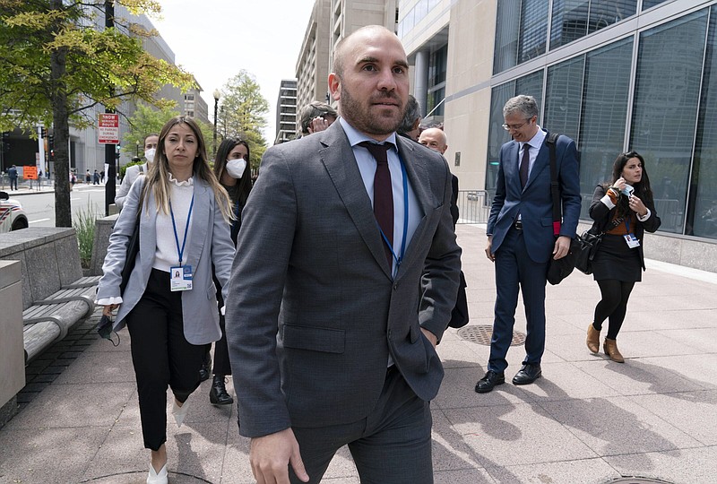 FILE - Argentina's Economy Minister Martin Guzman walks outside of the International Monetary Fund, IMF, building during the IMF Spring Meetings, in Washington, April 21, 2022. Guzman announced his resignation on Saturday, July 2, via twitter.  (AP Photo/Jose Luis Magana, File)