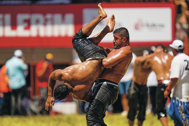 Wrestlers compete Sunday during the 661st annual Historic Kirkpinar Oil Wrestling championship in Edirne, Turkey. (AP/Francisco Seco)