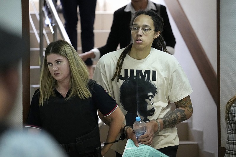 WNBA star and two-time Olympic gold medalist Brittney Griner is escorted to a courtroom for a hearing, in Khimki just outside Moscow, Russia, Friday, July 1, 2022. U.S. basketball star Brittney Griner is set to go on trial in a Moscow-area court Friday. The proceedings that are scheduled to begin Friday come about 4 1/2 months after she was arrested on cannabis possession charges at an airport while traveling to play for a Russian team. (AP Photo/Alexander Zemlianichenko)