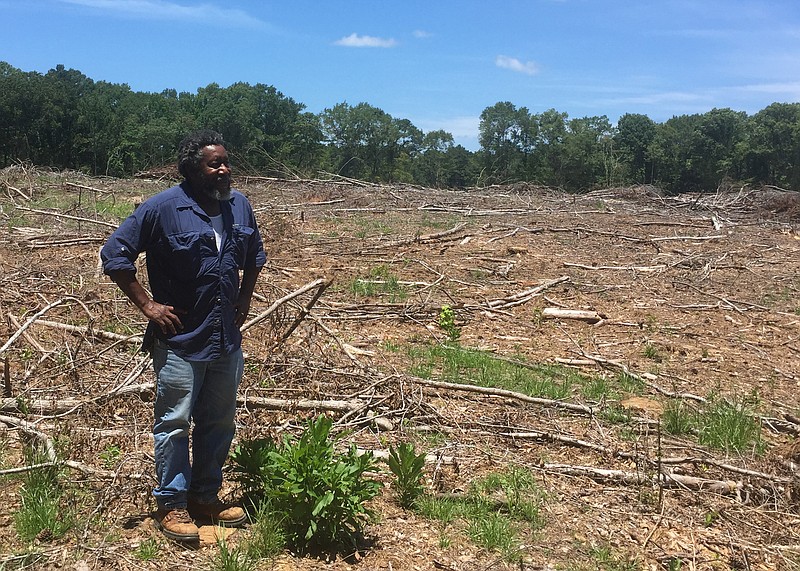 Charley Williams, veteran NRCS soil conservationist, conducts a site visit at the property of a landowner who received EQIP funds for planting timber. - Submitted photo