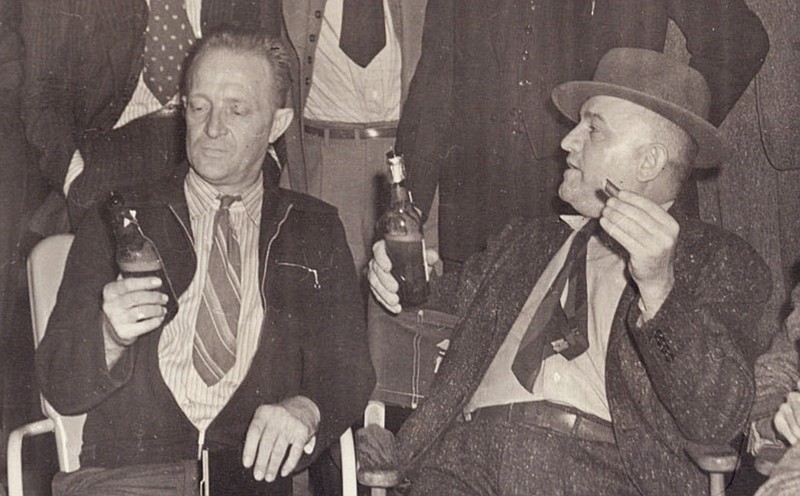 Old pals Joe Wirges (left) and Heinie Loesch regard their drinks in 1940, during an Arkansas Gazette staff party. (Democrat-Gazette archives)