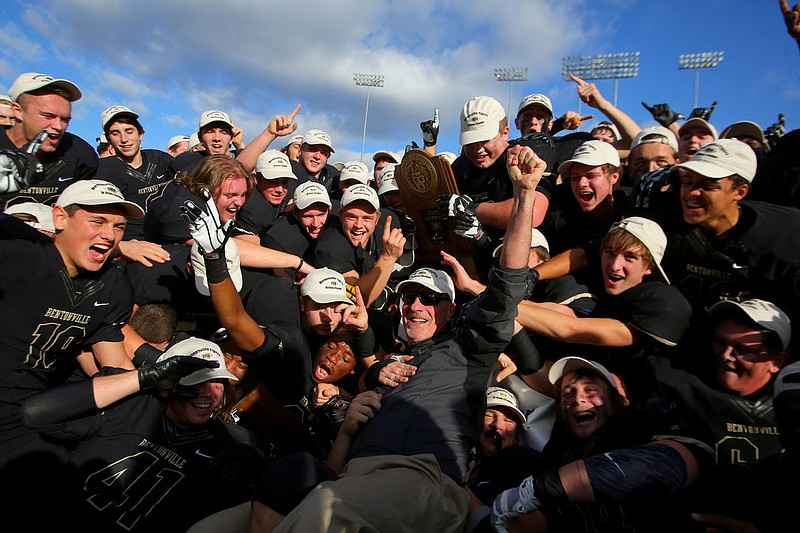 Bentonville’s coach Barry Lunney Sr. falls into a pack of celebrating Tigers after the team defeated Fayetteville during the Class 7A state championship football game Dec. 6, 2014, at War Memorial Stadium in Little Rock.

(File Photo/Arkansas Democrat-Gazette)